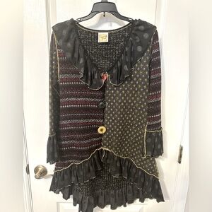 Unique cardigan with side pockets. Fun buttons and ruffles !